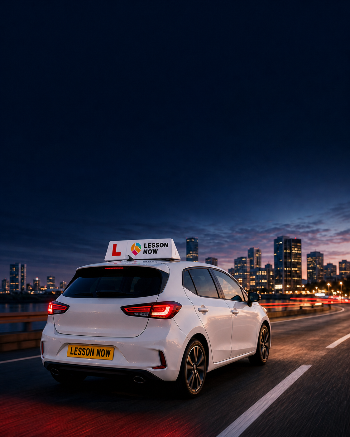 Lesson Now learner car travelling through a city at dusk